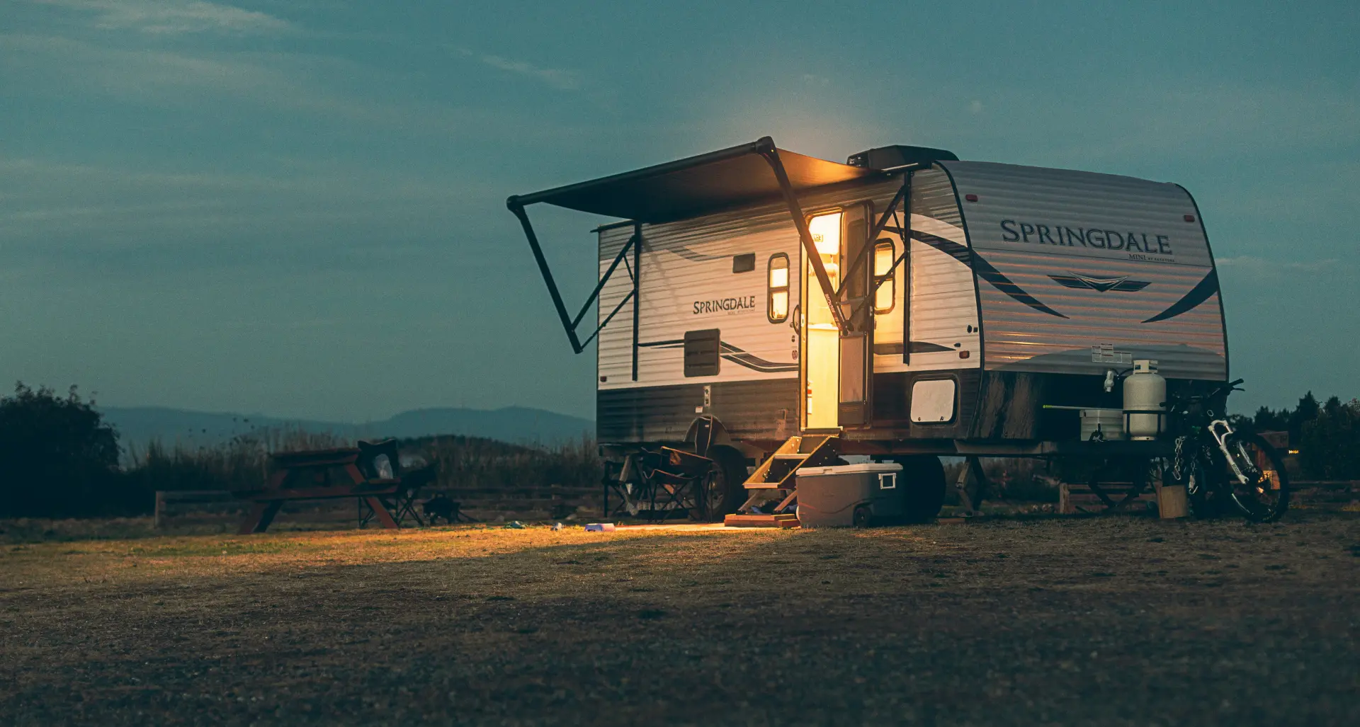 A popup camper in a scenic setting.
